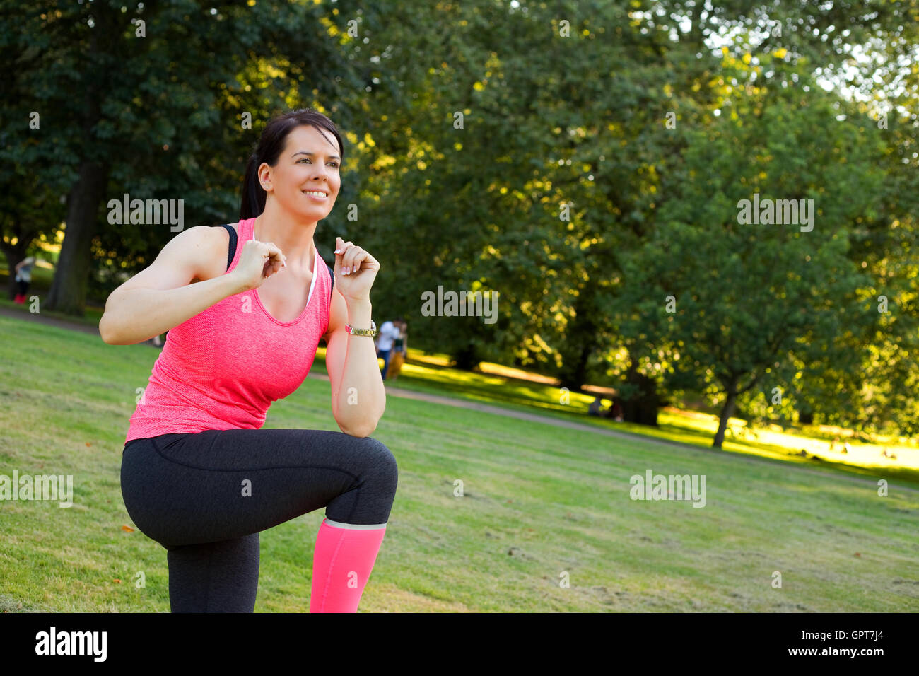 Young woman in the park exercising Stock Photo - Alamy