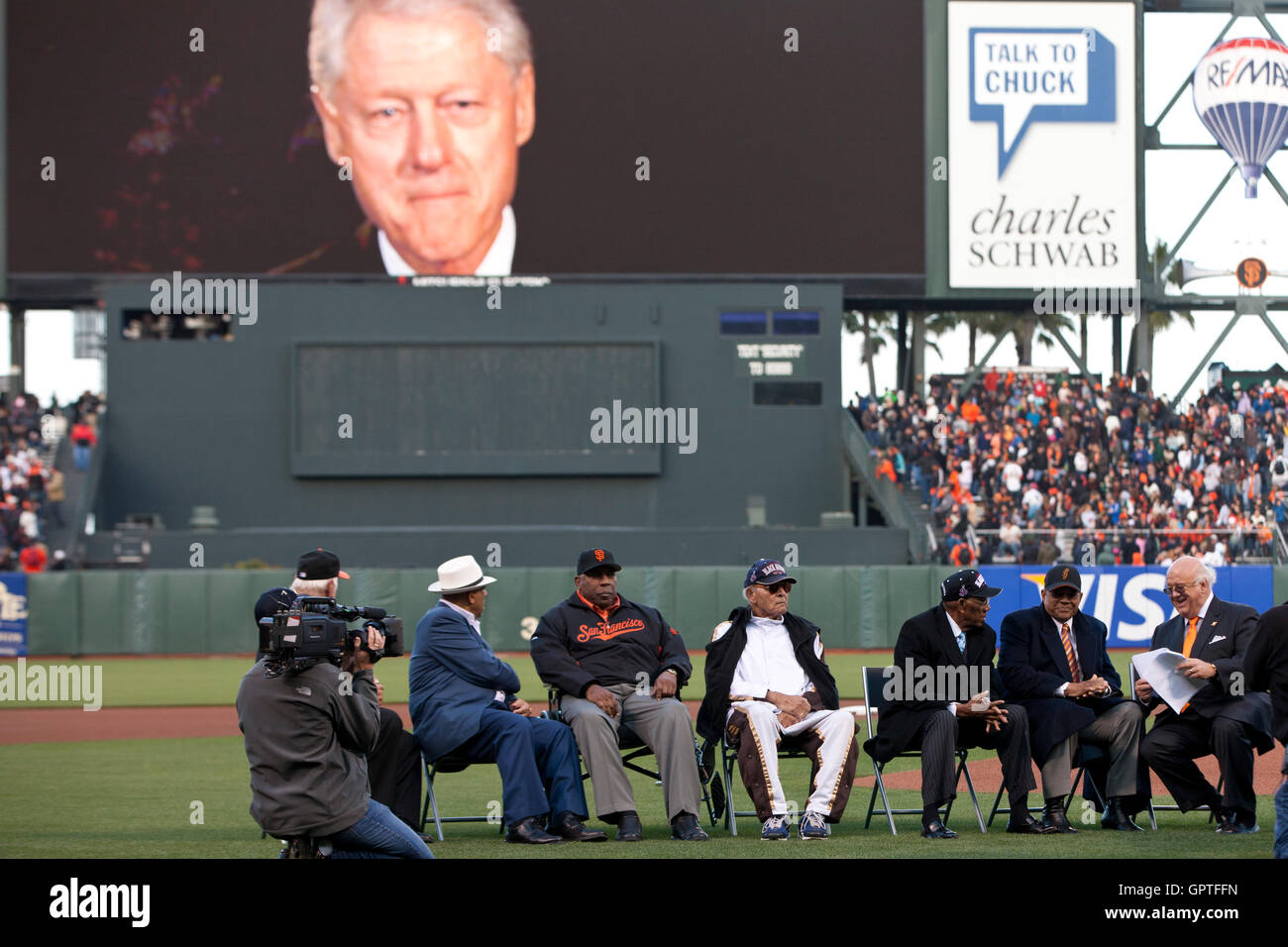 May 6, 2011; San Francisco, CA, USA;  Former president Bill Clinton delivers a video tribute to Willie Mays (second from right) as part of his 80th birthday celebration before the game between the San Francisco Giants and the Colorado Rockies at AT&T Park Stock Photo