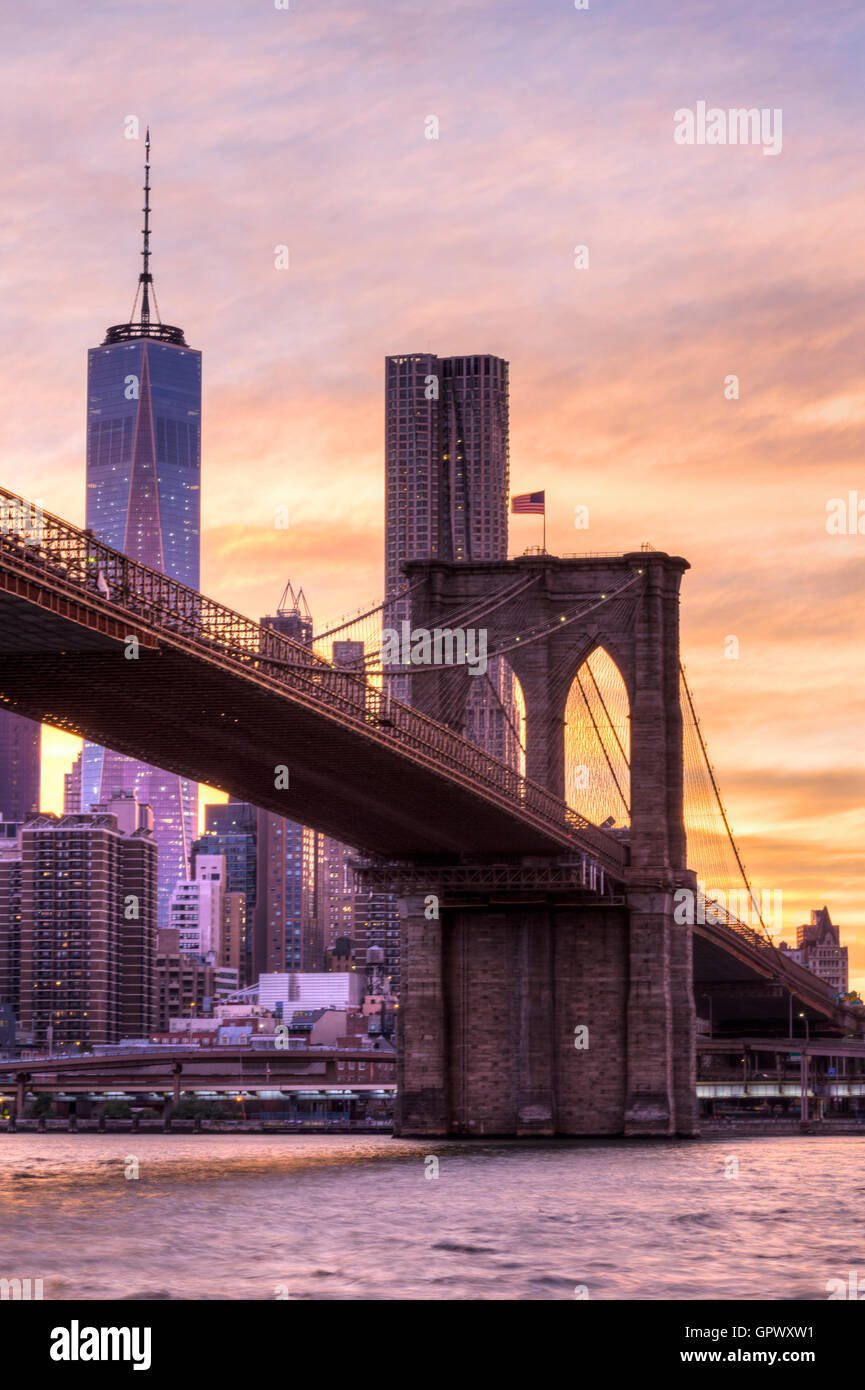 Sunset shot of the Brooklyn Bridge and One World Trade Center seen from the Brooklyn side of the bridge in New York. Stock Photo
