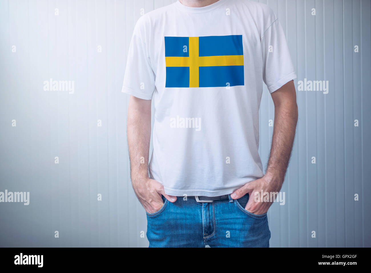 Handsome casual man wearing white t-shirt with Swedish flag printed on chest Stock Photo