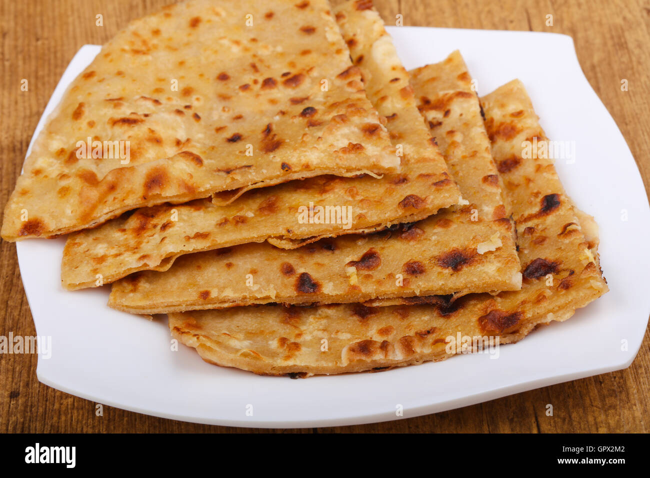 Indian bread roti on the plate in wood background Stock Photo - Alamy