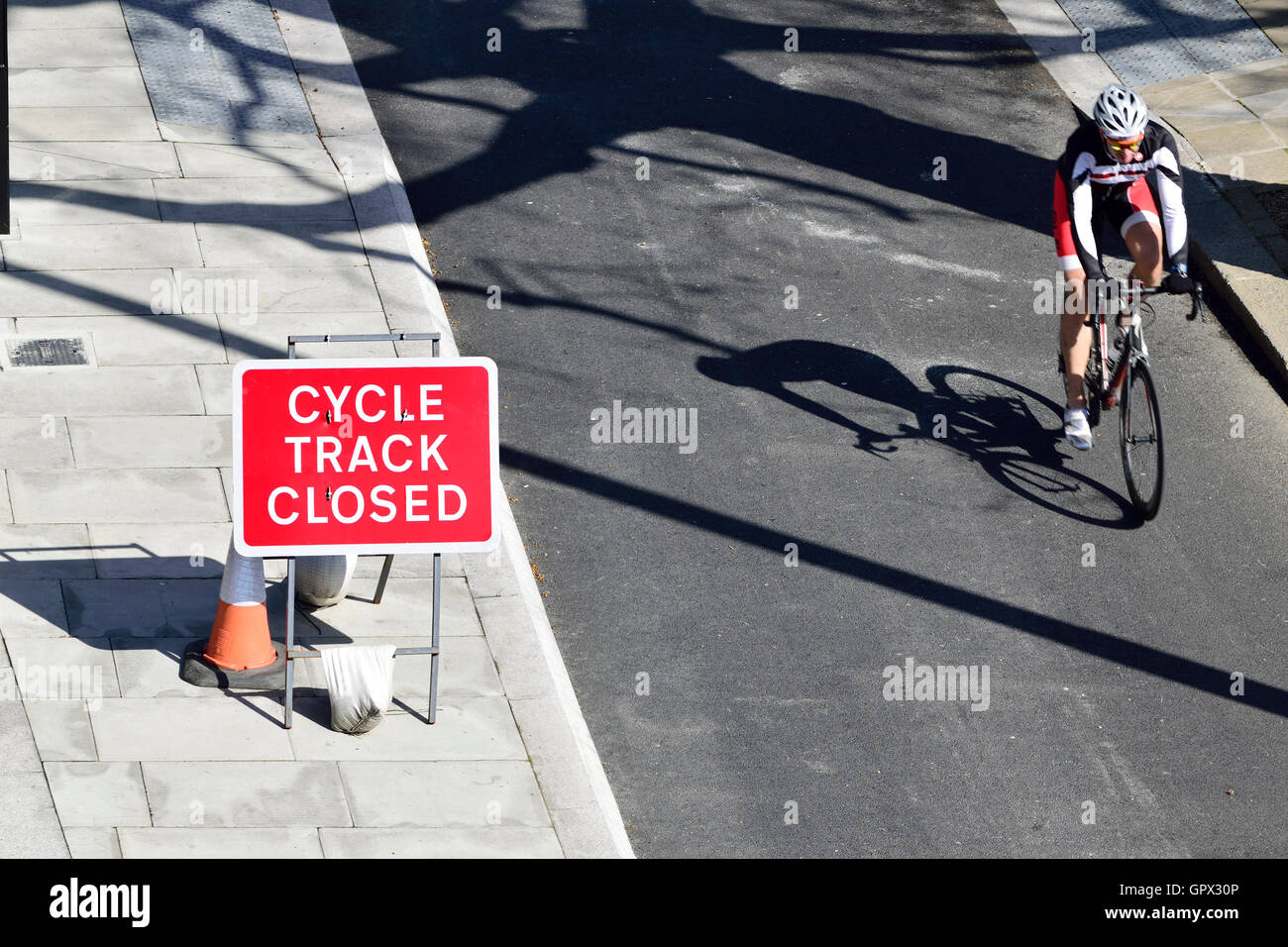 London, England, UK. Cycle Track Closed sign on the Victoria Embankment. People cycling past Stock Photo