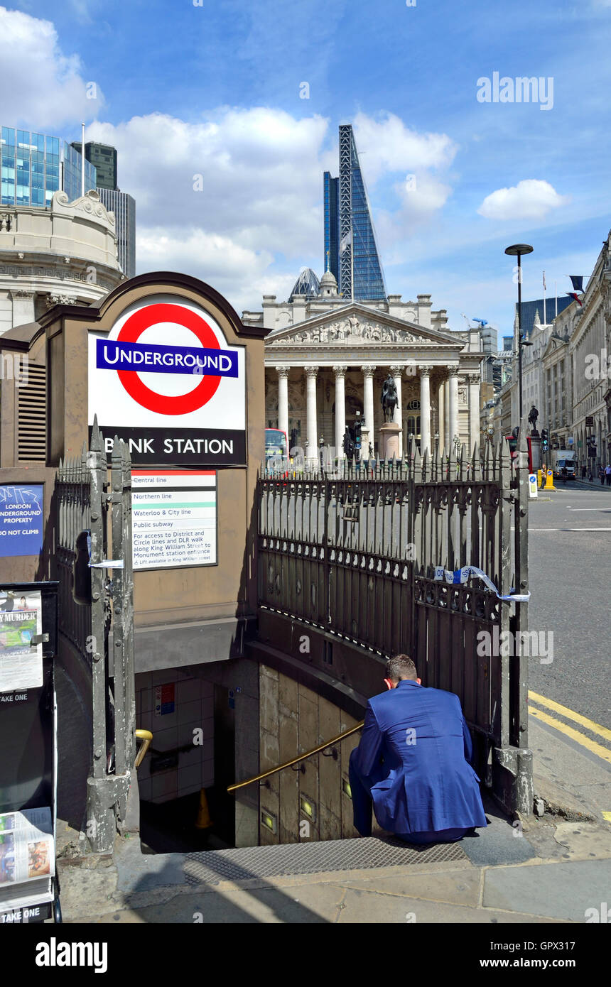 London, England, UK. Bank tube station and Royal Exchange - man on the steps using his mobile phone Stock Photo
