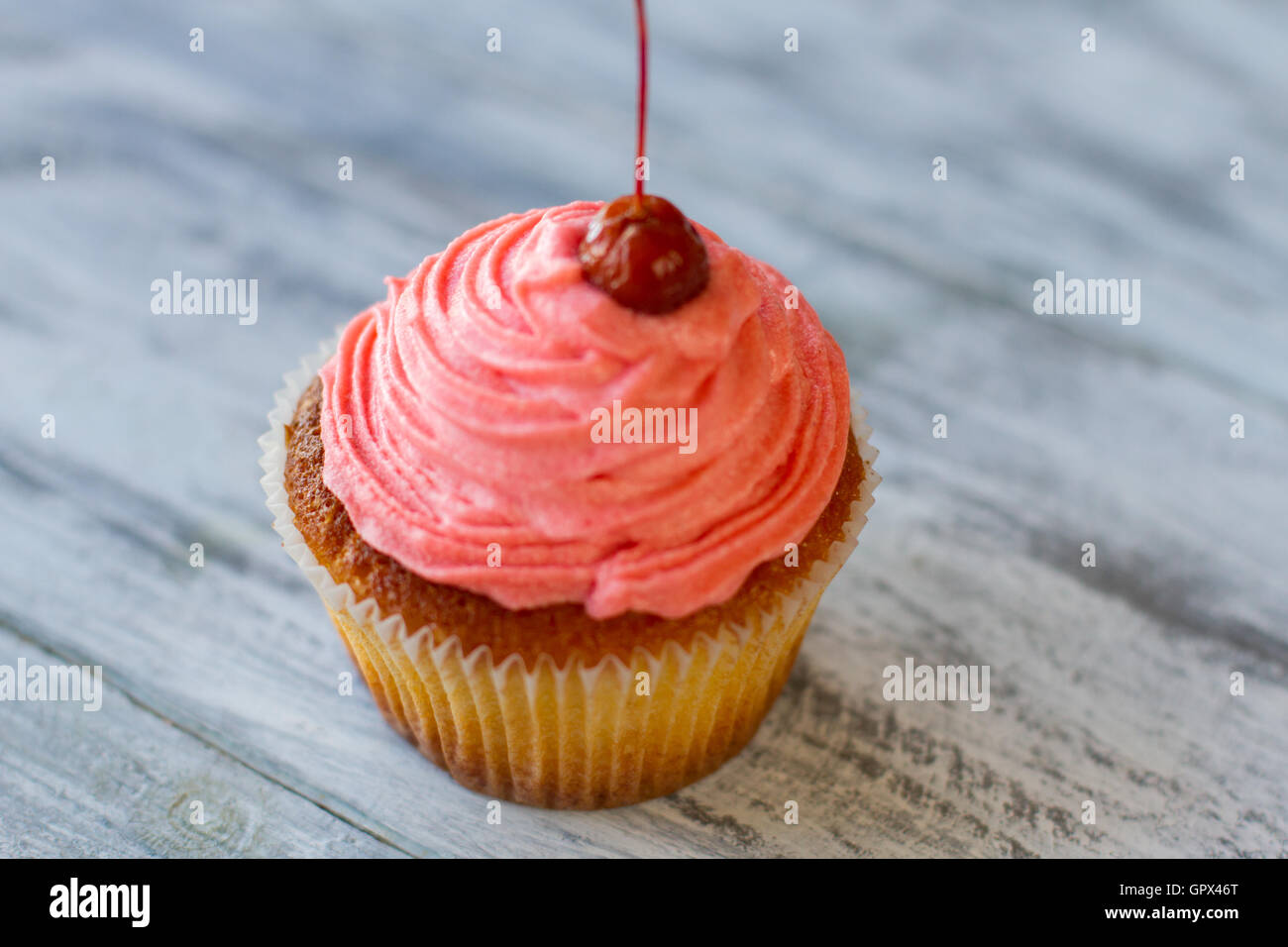 Cupcake on wooden surface Stock Photo Alamy