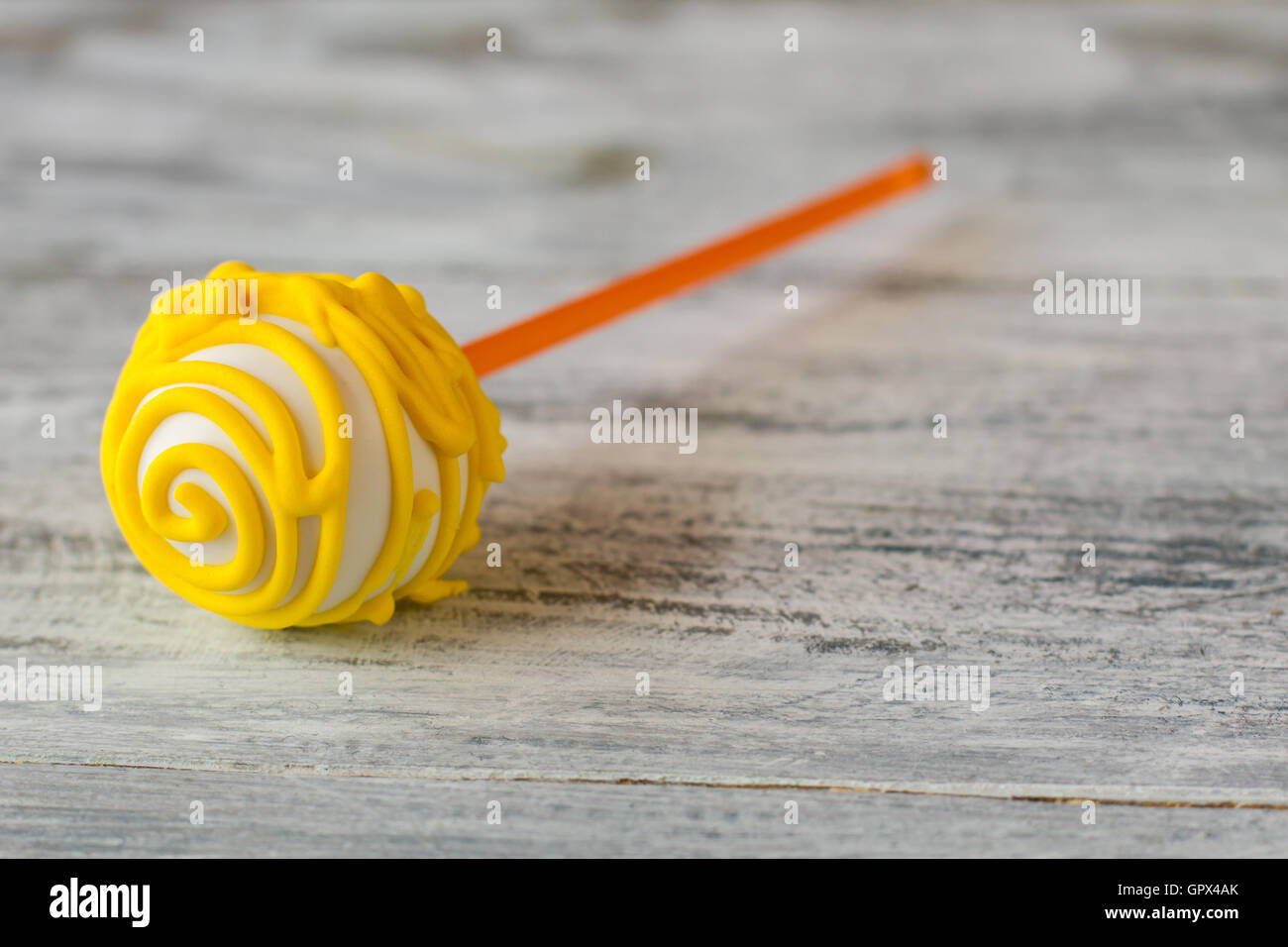 Cake pop with yellow icing. Stock Photo