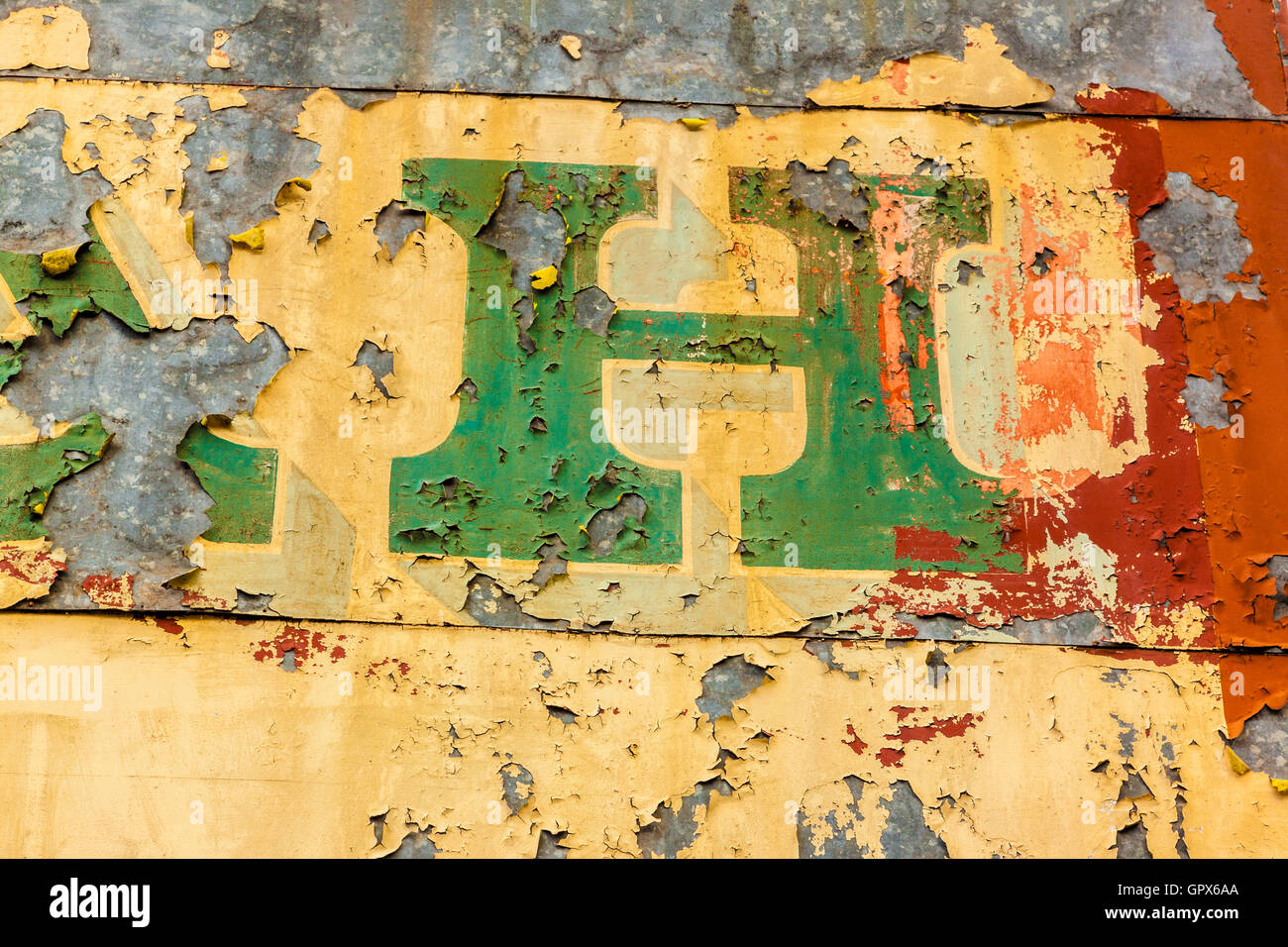 Handpainted letters of a shop signboard faded, peeling and weathered Stock Photo