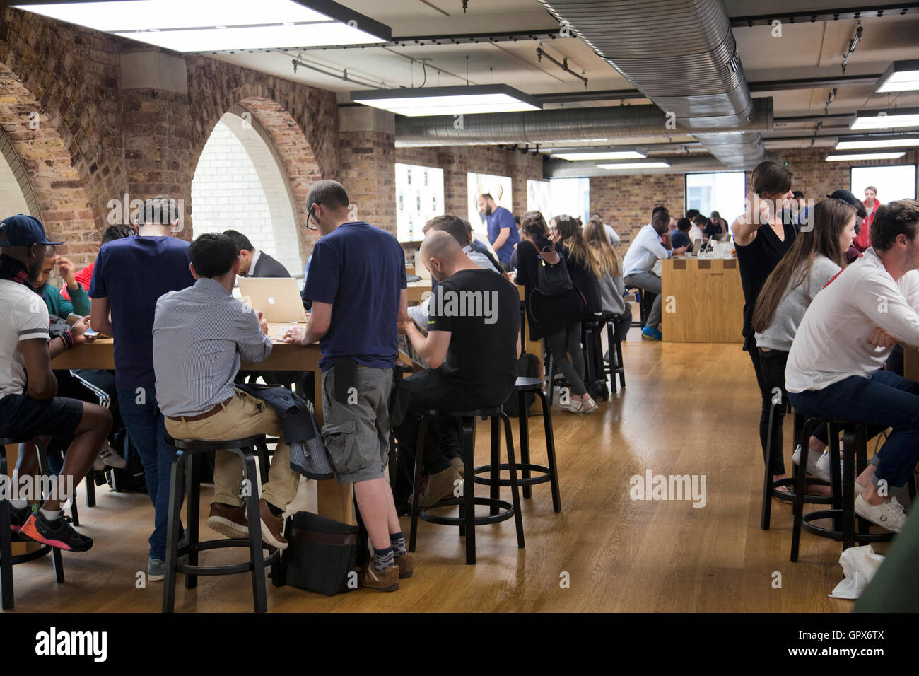 Apple Store Interior Genius Bar with Customers and Staff in Covent Garden - London UK Stock Photo