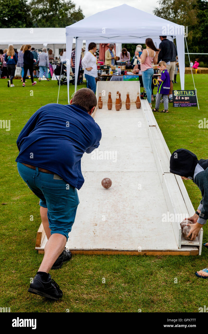 People Playing Skittles At The Annual Hartfield Village Fete, Alfriston, East Sussex, UK Stock Photo