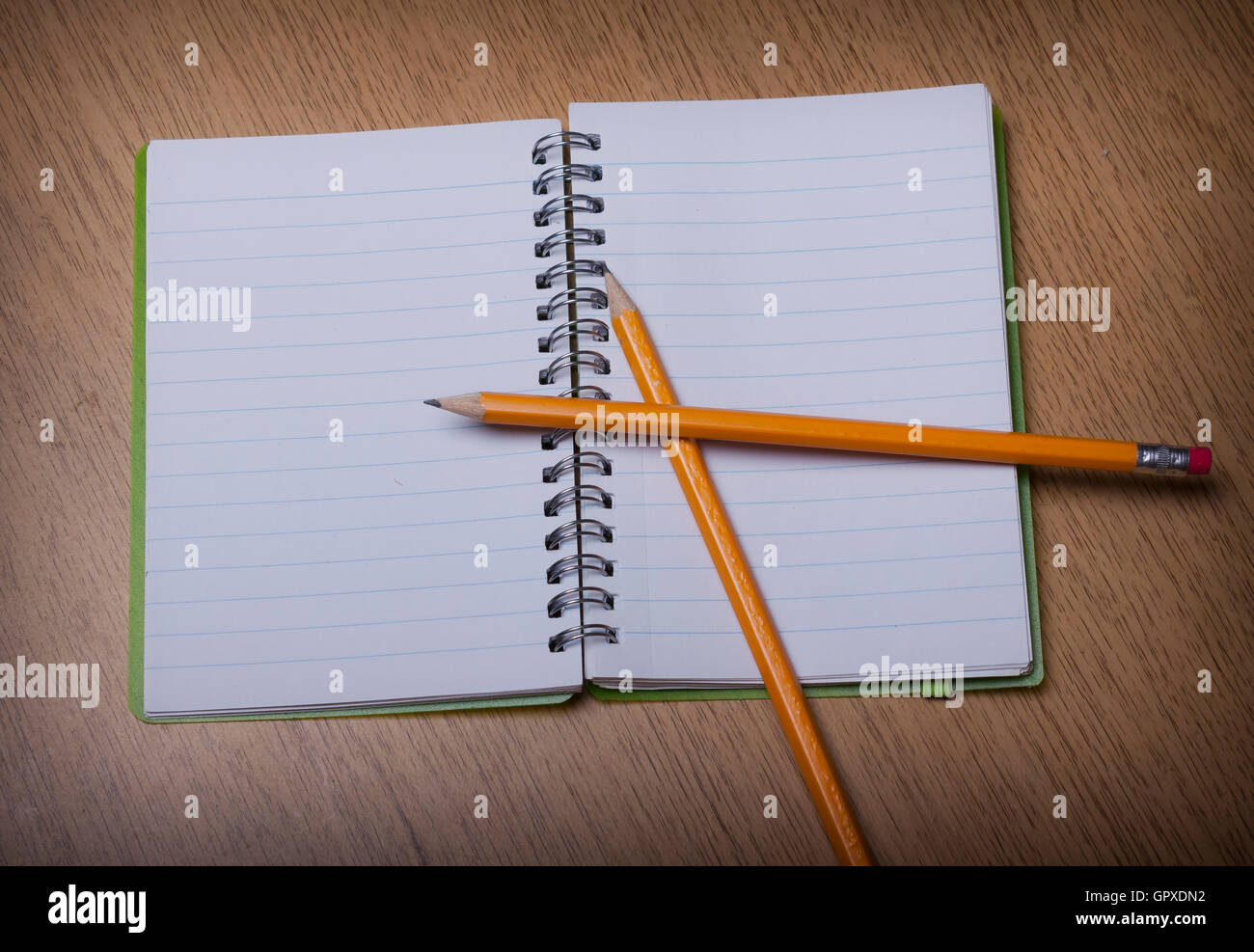 open  notebook on a wooden desk with pencil Stock Photo
