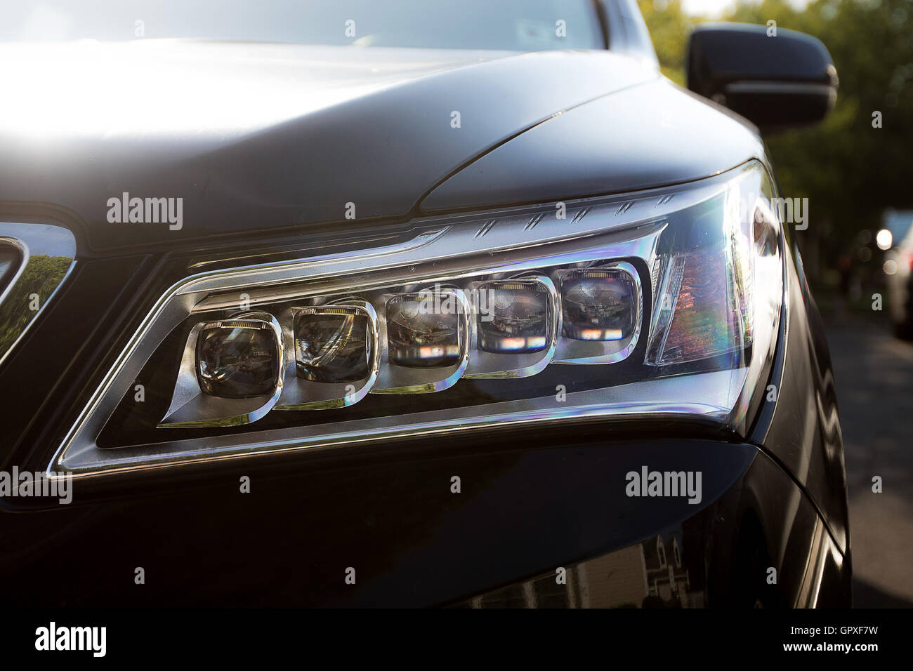A closeup of a headlight of an SUV. Stock Photo
