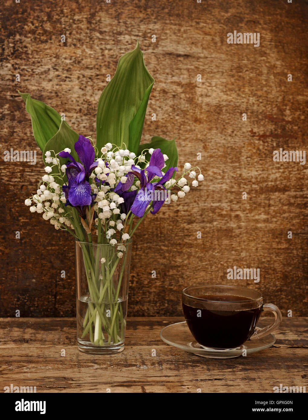 Still-life bouquet of lily of the valley with blue irises Stock Photo ...