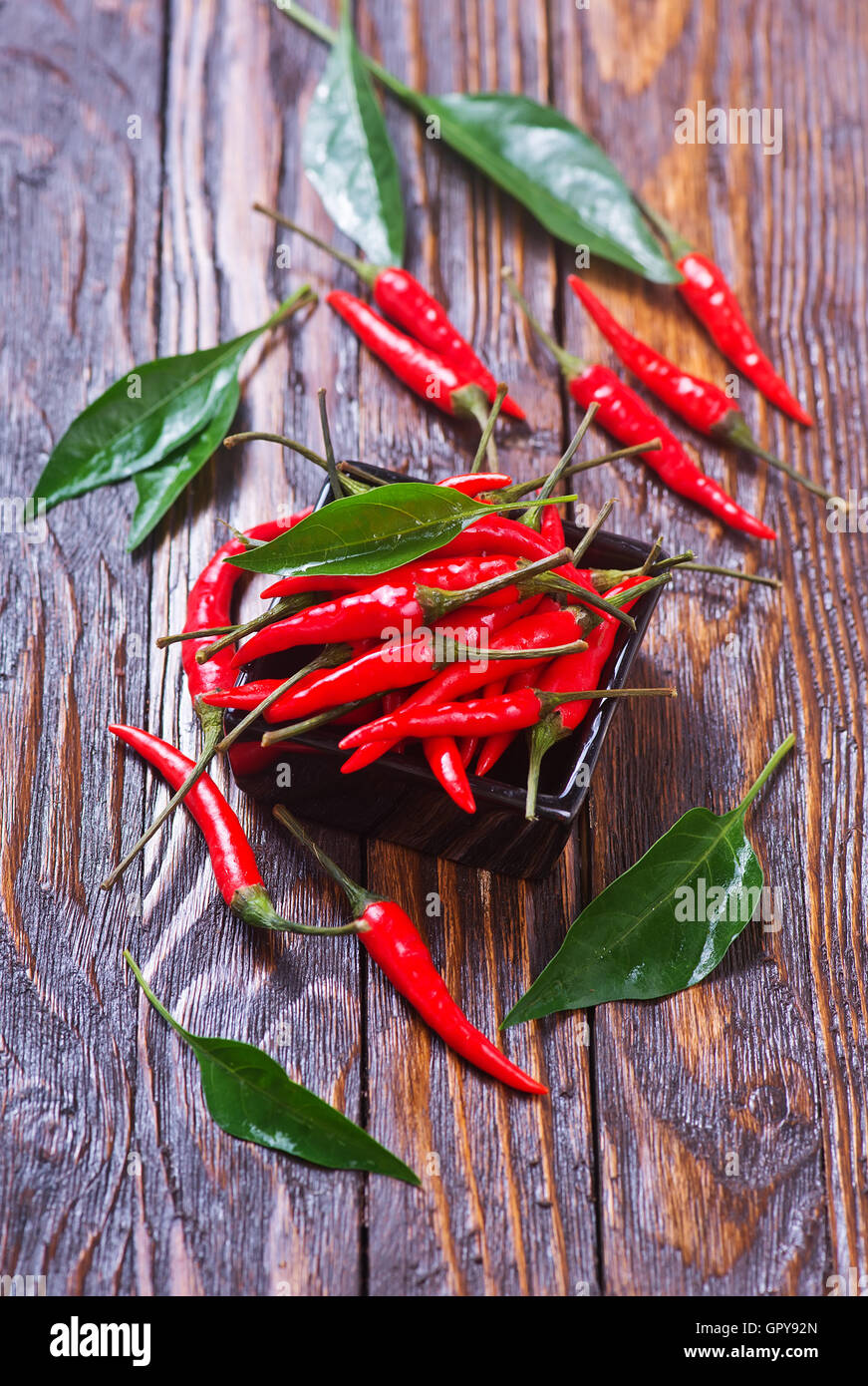 red hot chilli peppers on a table Stock Photo - Alamy