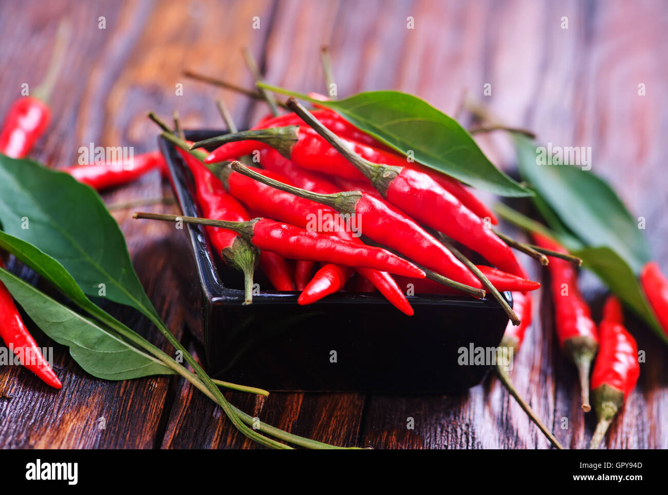 red hot chilli peppers on a table Stock Photo - Alamy