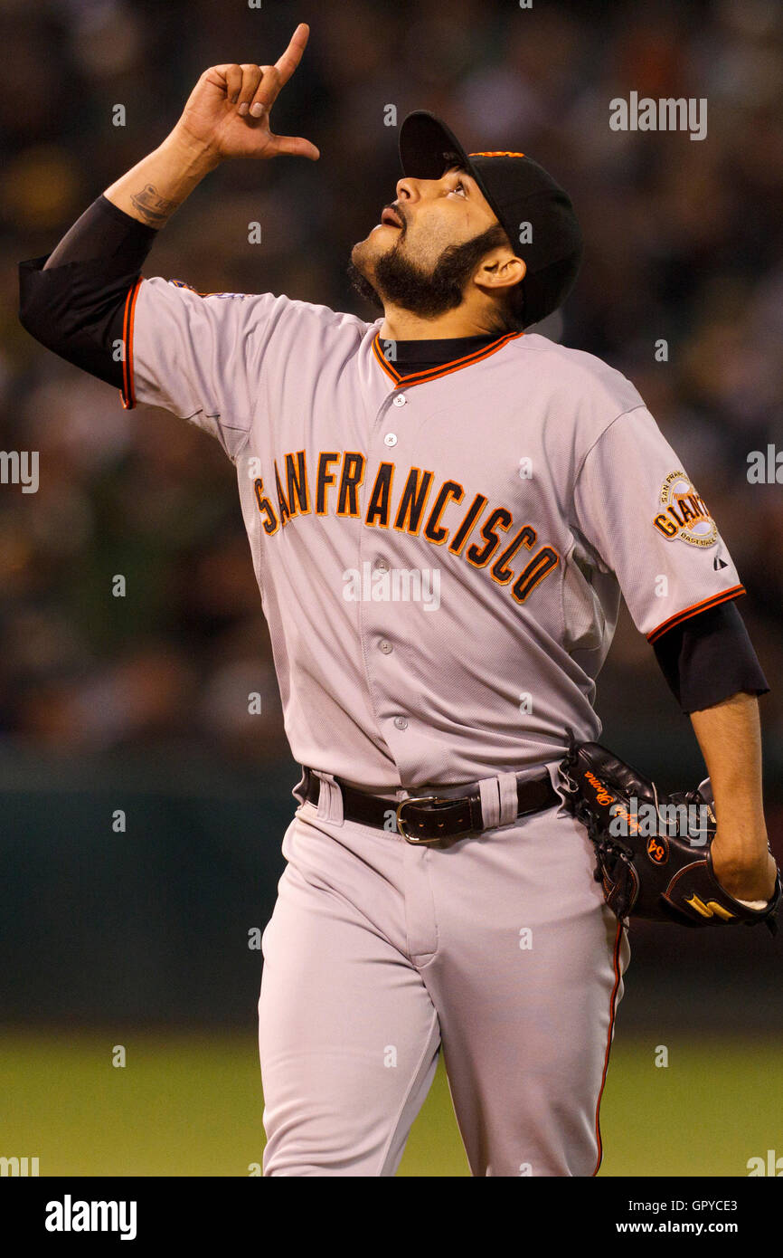 June 18, 2011; Oakland, CA, USA;  San Francisco Giants relief pitcher Sergio Romo (54) celebrates after striking out a batter against the Oakland Athletics during the eighth inning at the O.co Coliseum.  Oakland defeated San Francisco 4-2. Stock Photo