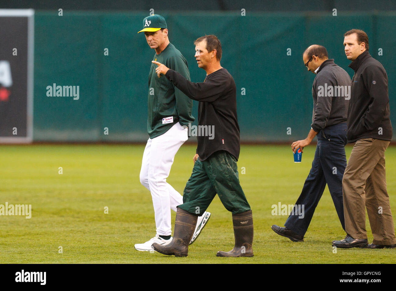 June 28, 2011; Oakland, CA, USA; Oakland Athletics manager Bob Melvin (left) inspects the field