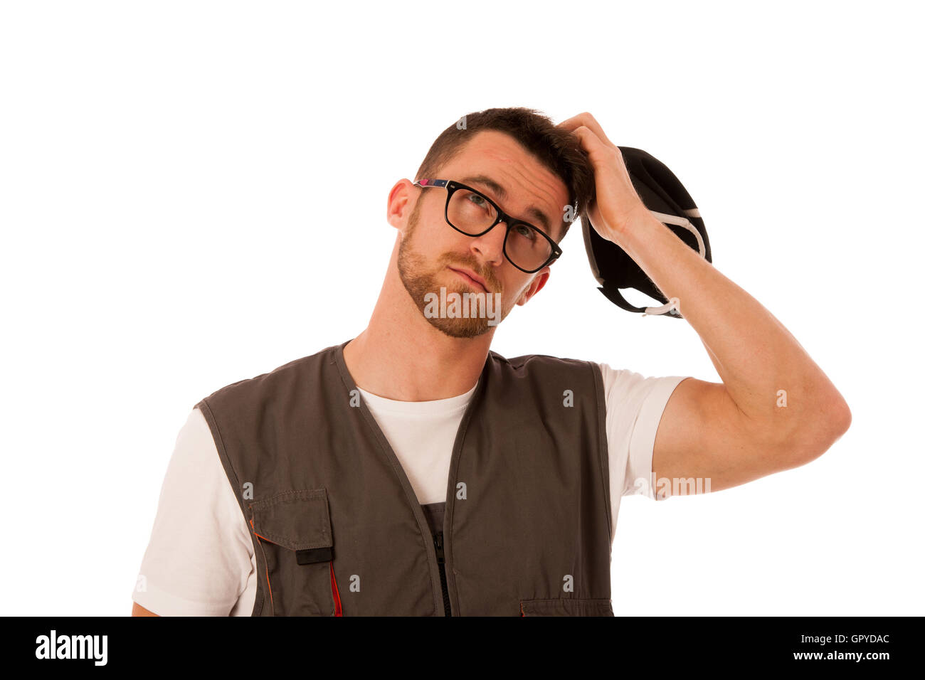 Handyman in work clothing scratching on head, looking up, thinking isolated over white. Stock Photo