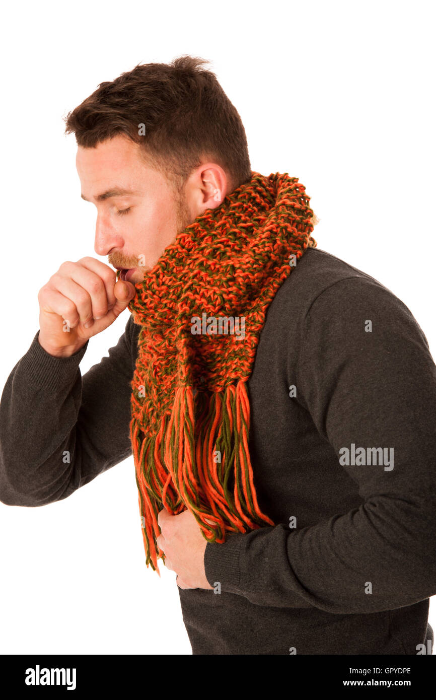 Man with flu and fever wrapped in scarf holding cup of healing tea and coughing isolated over white. Stock Photo