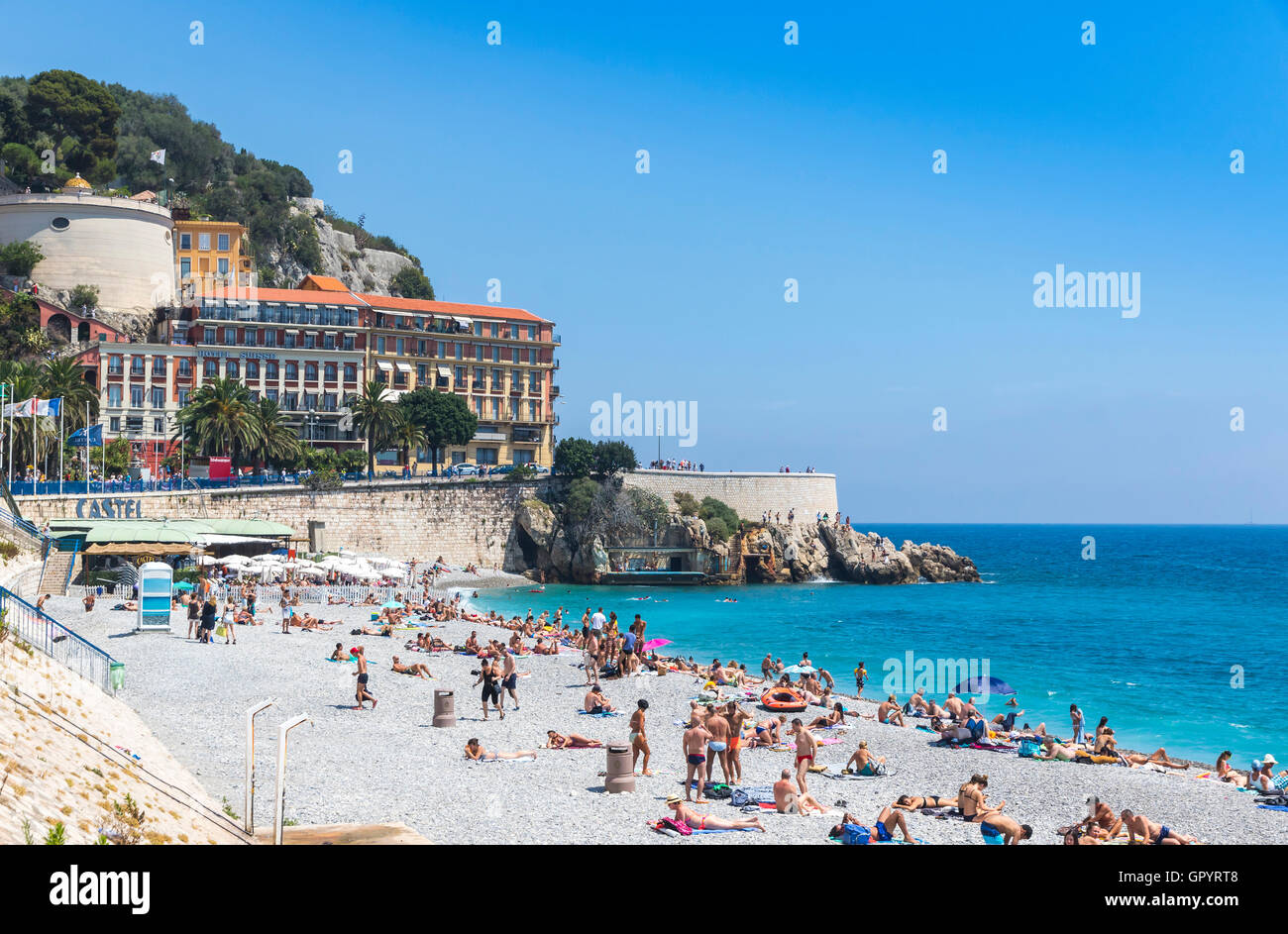 Crowded municipal beach near Promenade des Anglais in City of Nice, Cote D'azur, Mediterranean sea, France Stock Photo