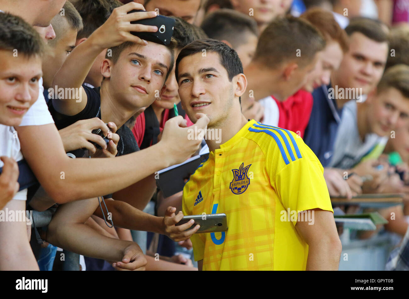Player Taras Stepanenko makes selfie with fans during Open training session of Ukraine National Football Team Stock Photo