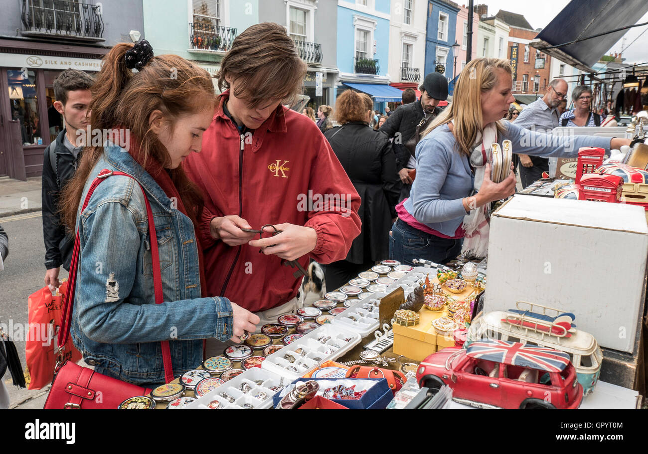 Buying souvenirs at  the Portobello Road Market in London Notting Hill Gate W11 Stock Photo