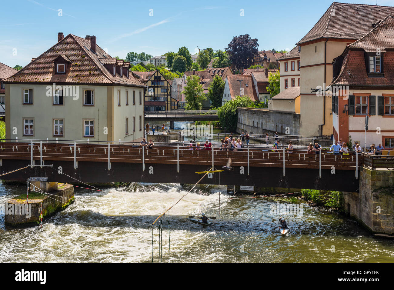 Tourists on a bridge and canoe slalom on the River Regnitz, Bamberg, Bavaria, Germany, Europe. Stock Photo