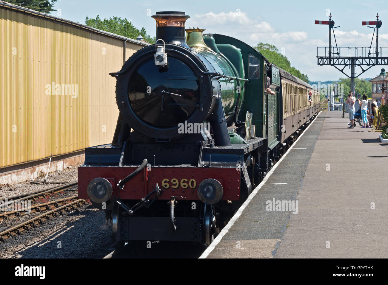Steam engine 6960 Raveningham Hall pulling a train into the West Somerset Railway Station at Minehead in Somerset Stock Photo