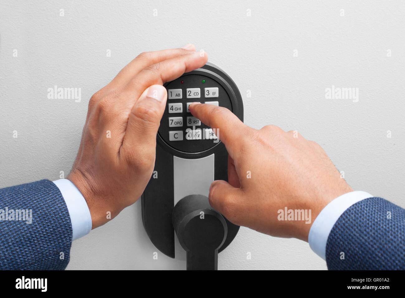 Interracial businessman hand entering security system code Stock Photo
