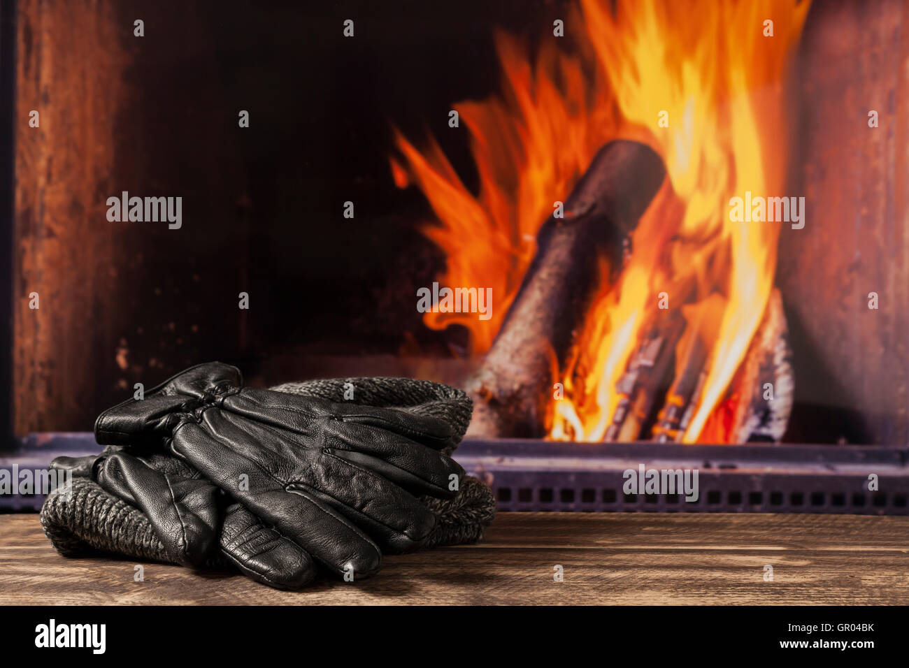 drying wet clothes and umbrella at fireplace in fall autumn winter
