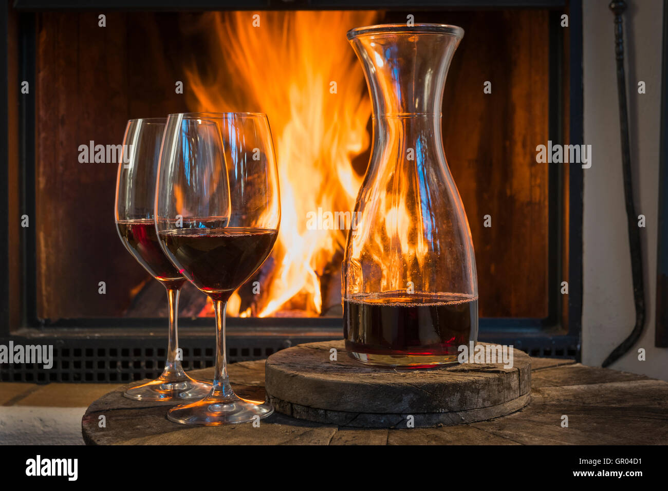relaxing at fireplace in fall autumn winter with wine Stock Photo