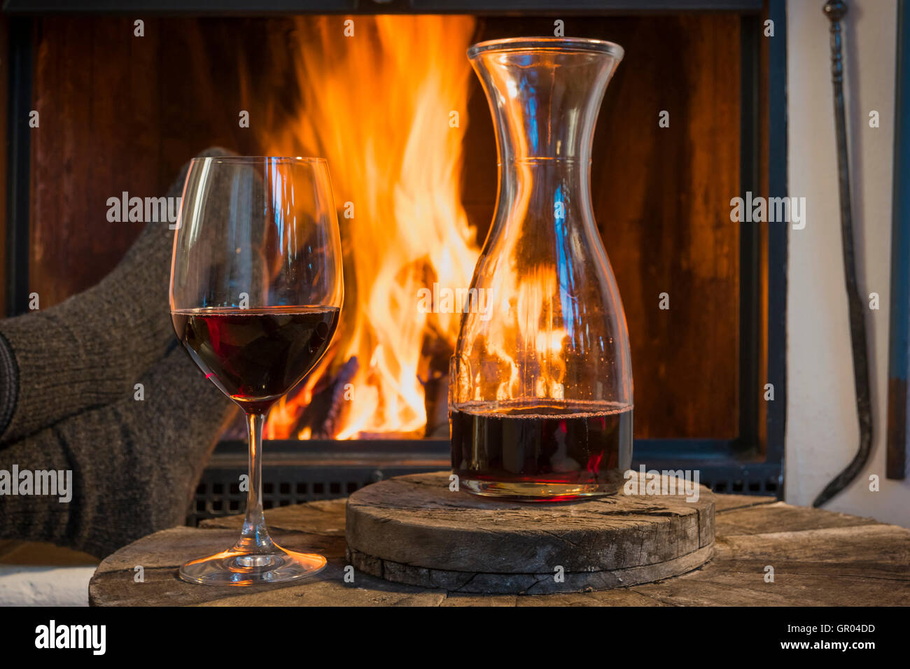 relaxing at fireplace in fall autumn winter with wine Stock Photo