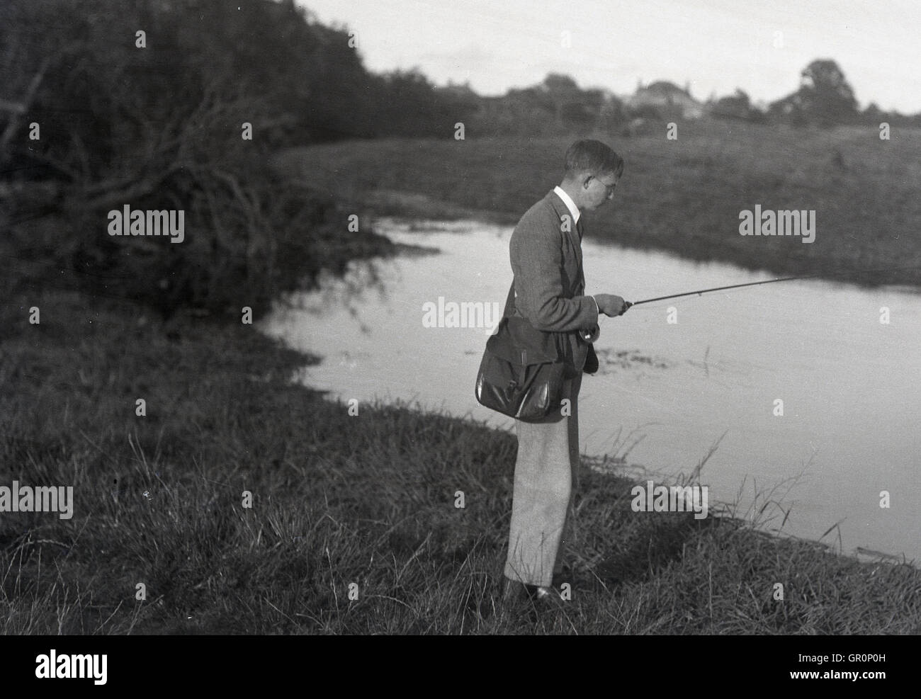 1930s, historical, young man with satchel standing fishing beside the River  Derwent at Yedingham, North Yorkshire, England Stock Photo - Alamy