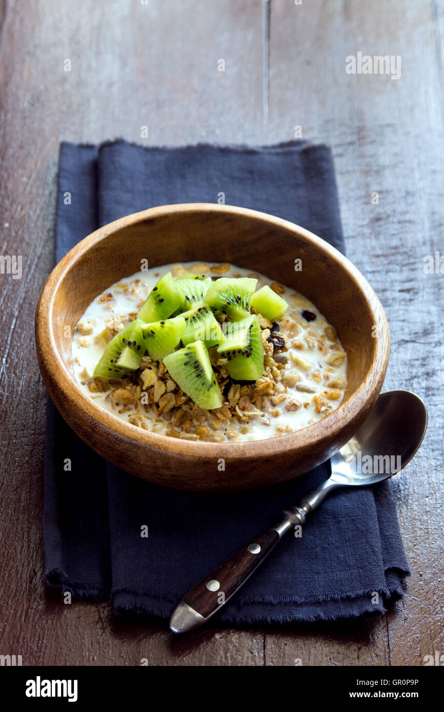 Homemade granola with milk and kiwi for healthy breakfast Stock Photo