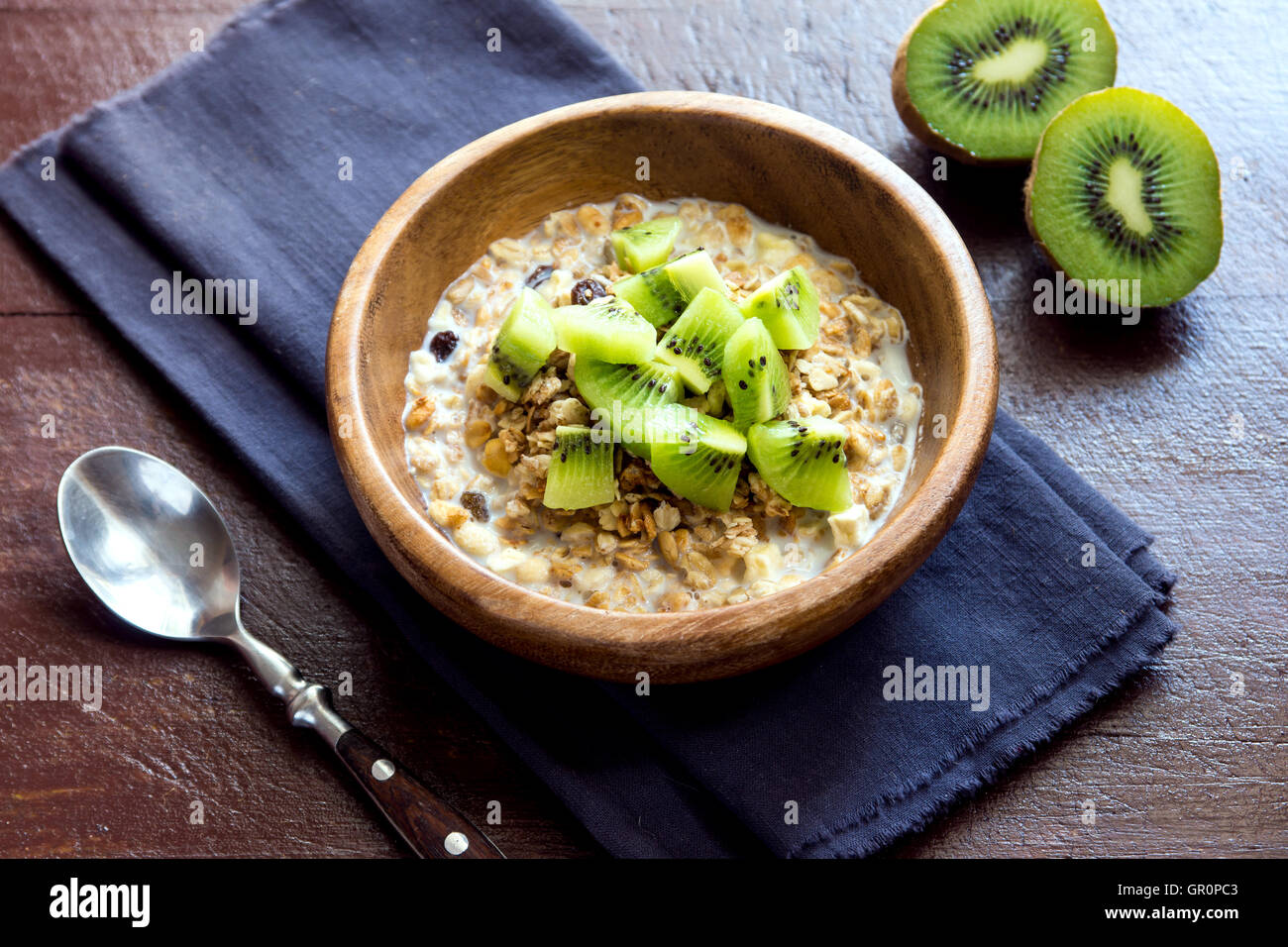 Homemade granola with milk and kiwi for healthy breakfast Stock Photo