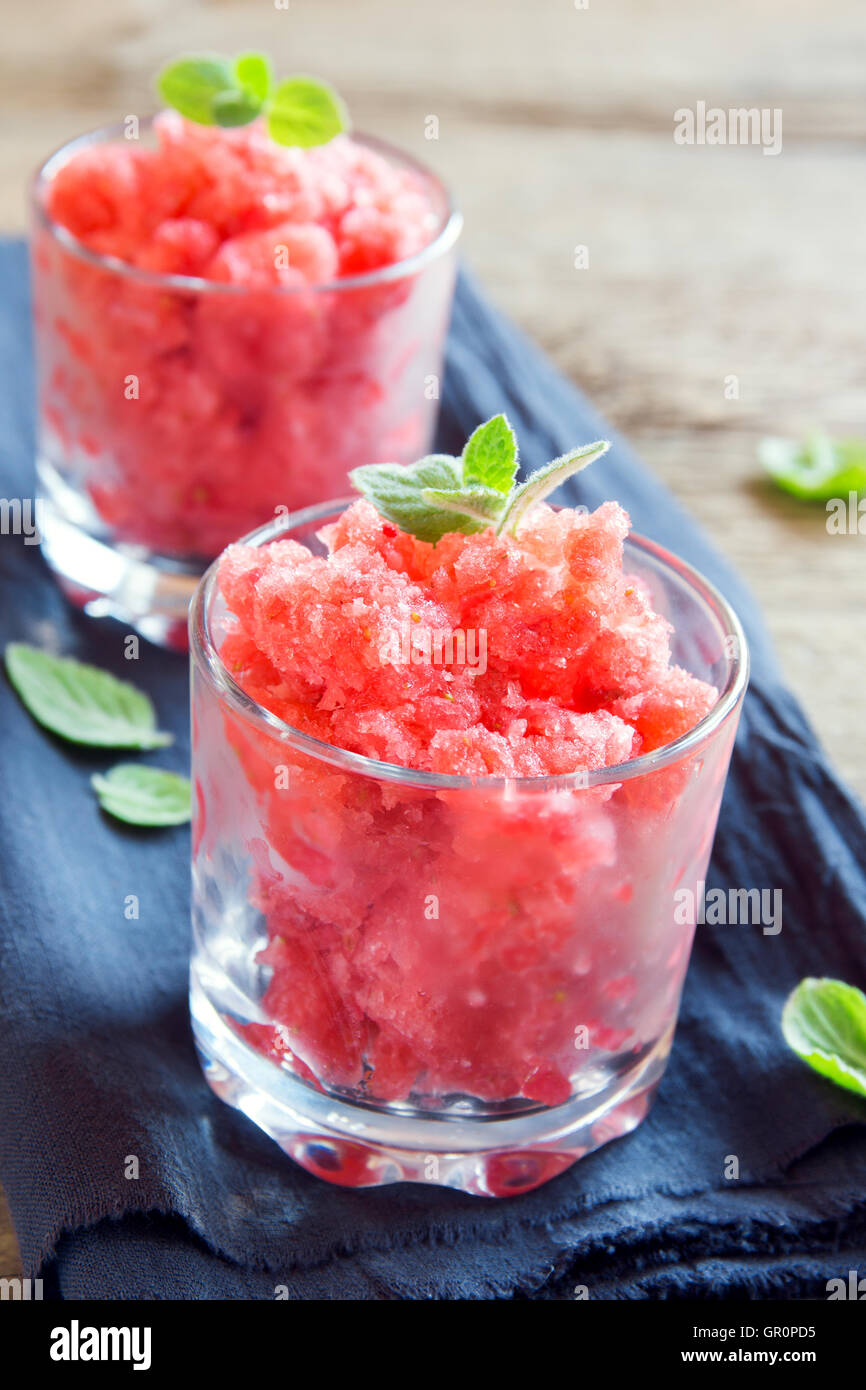 Strawberry granita with mint (frozen dessert) in portion glasses close