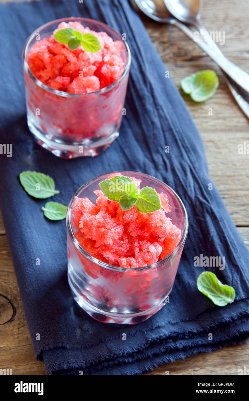 Strawberry granita with mint (frozen dessert) in portion glasses close
