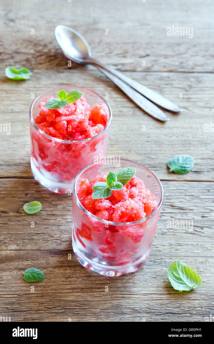 Strawberry granita with mint (slush, frozen dessert) in portion glasses