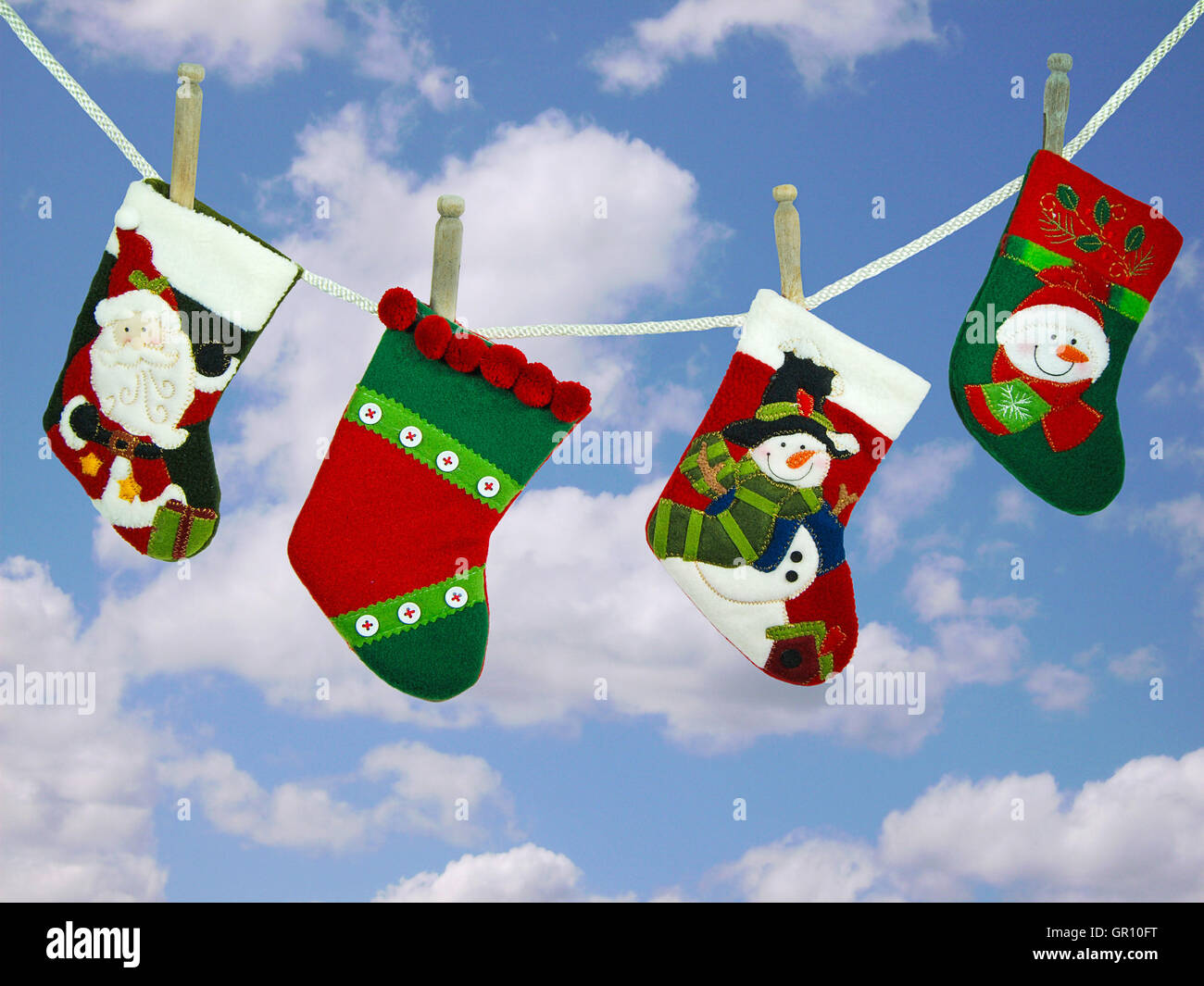 Christmas stocking hanging on clothesline with sky background Stock Photo