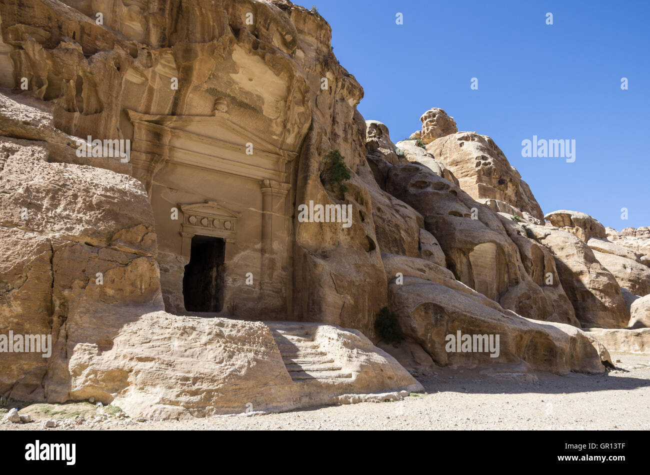 Cave tomb in Nabataean city of the Siq al-Barid in Jordan. It is known as the Little Petra Stock Photo