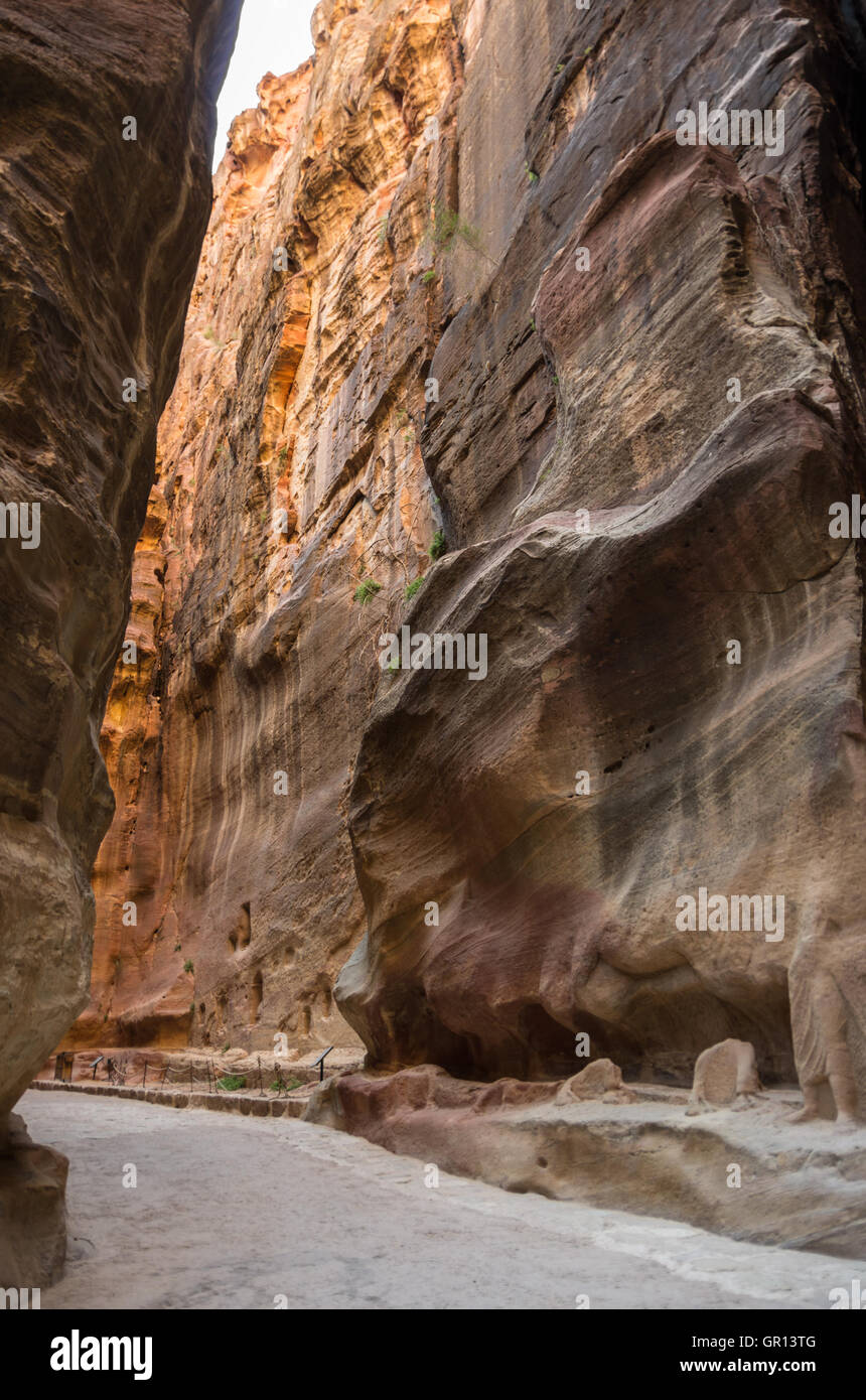 The Siq, the narrow slot-canyon that serves as the entrance passage to the hidden city of Petra, Jordan, Stock Photo