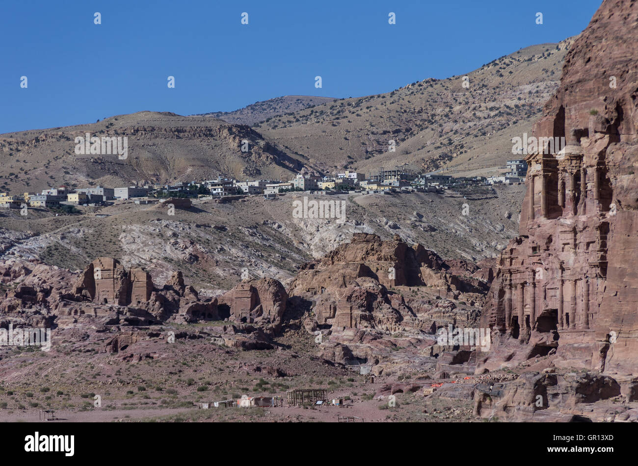 Ruin of Moghar Annassara (Christian Tombs )  in Petra and Uum Sayhoun village at background, Jordan Stock Photo