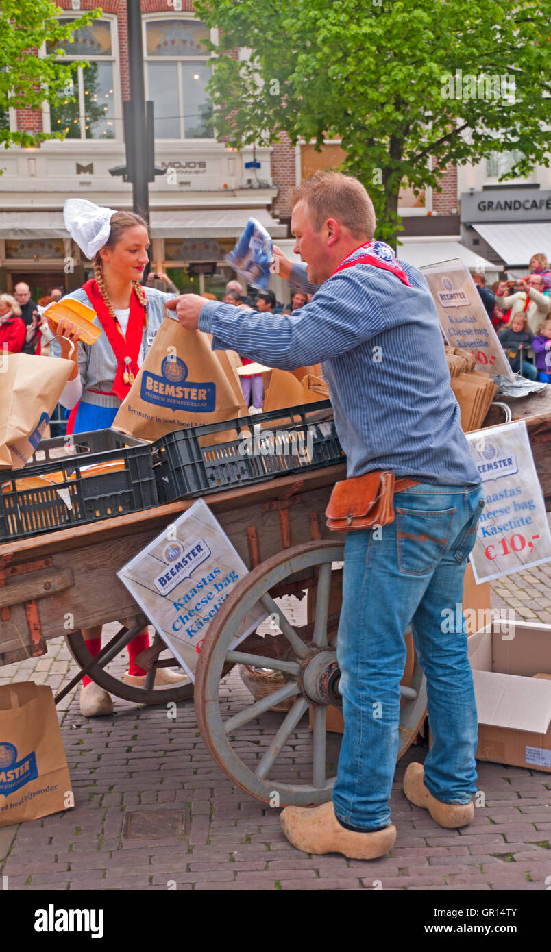 'Cheese girls' in traditional costumes sell samples at the Alkmaar Cheese Market, Holland Stock Photo