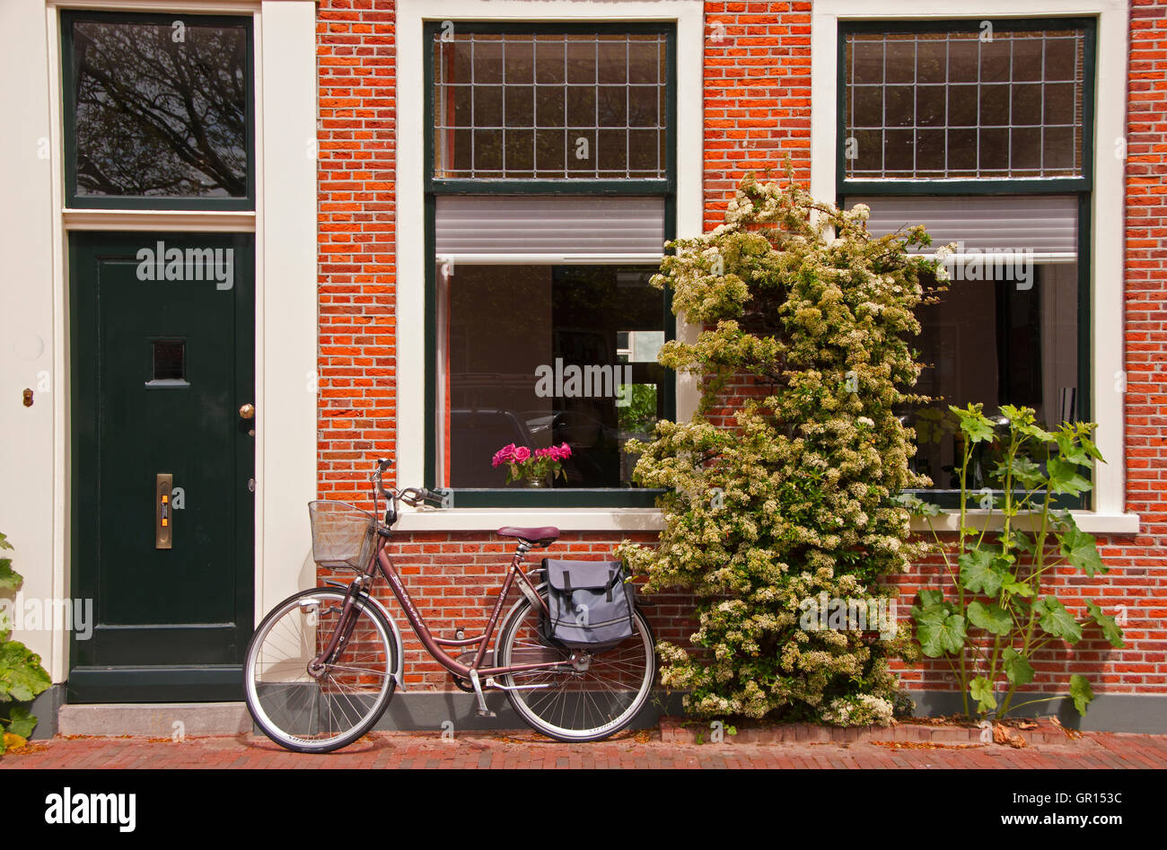 Typical private home with a bicycle parked in front Stock Photo