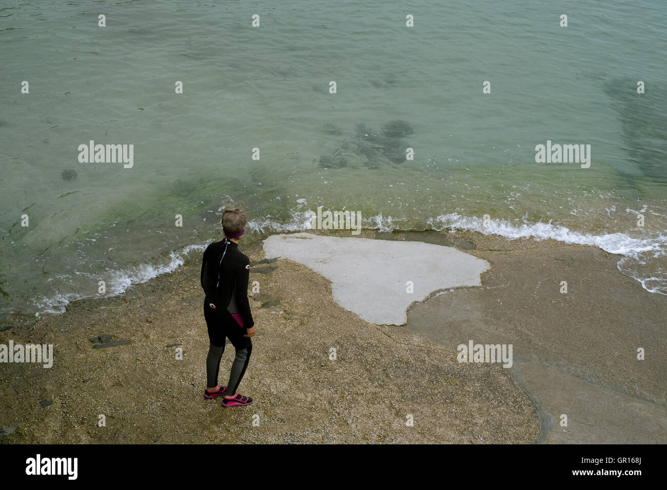 Portscatha, Cornwall, UK. 5th September, 2016. Woman prepares to enter the clear sea for an open water swim at Portscatho, Cornwall.  5th September 2016 Credit:  Mick Buston/Alamy Live News Stock Photo