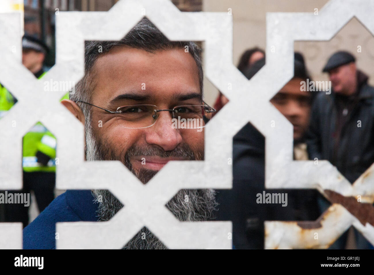 Brick Lane, London, December 13th 2013. Anjem Choudary, pictured, leads his 'Sharia Project' as they demonstrate in Brick Lane against the consumption of Alchohol blaming most of society's ills on drinking, and demanding that strict Sharia law be imposed to replace 'man-made' laws. Credit:  Paul Davey/Alamy Live News Stock Photo