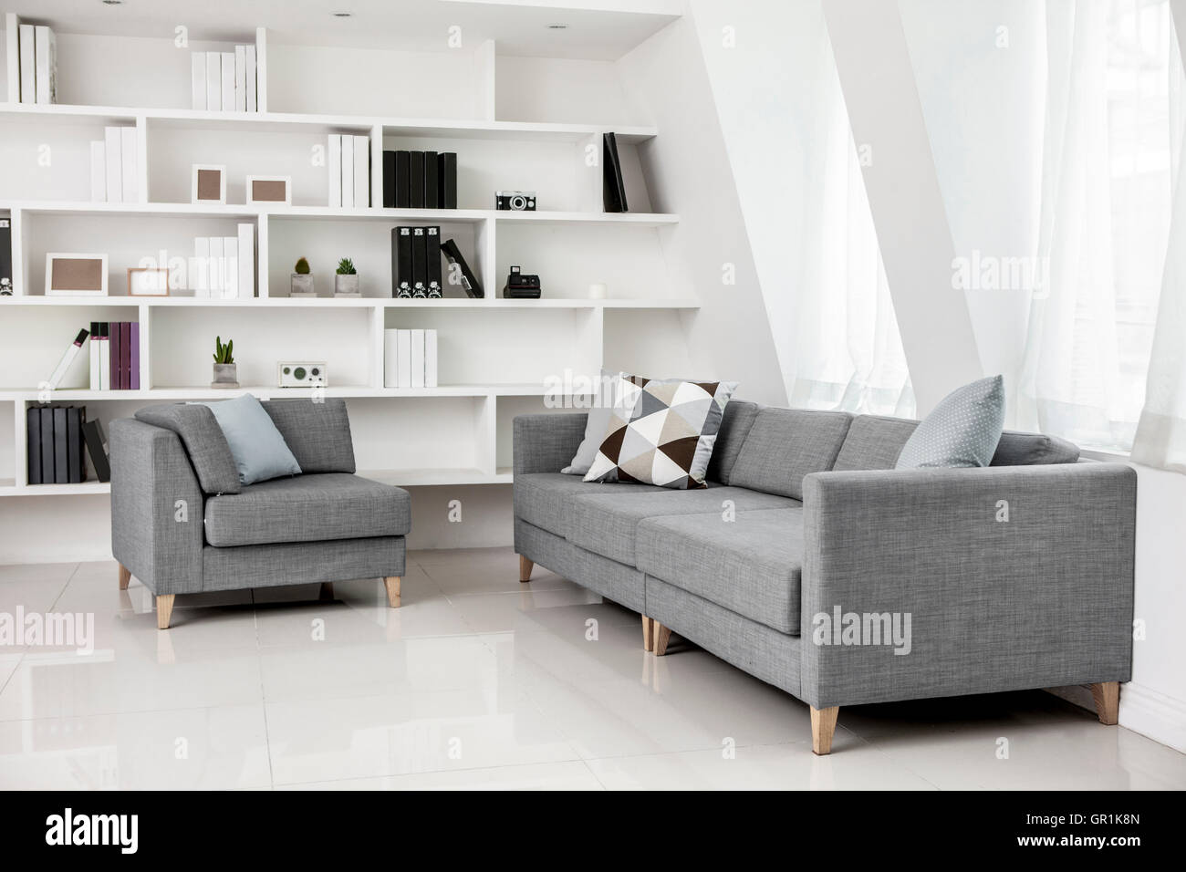 Living room interior with sofa and bookcases Stock Photo - Alamy