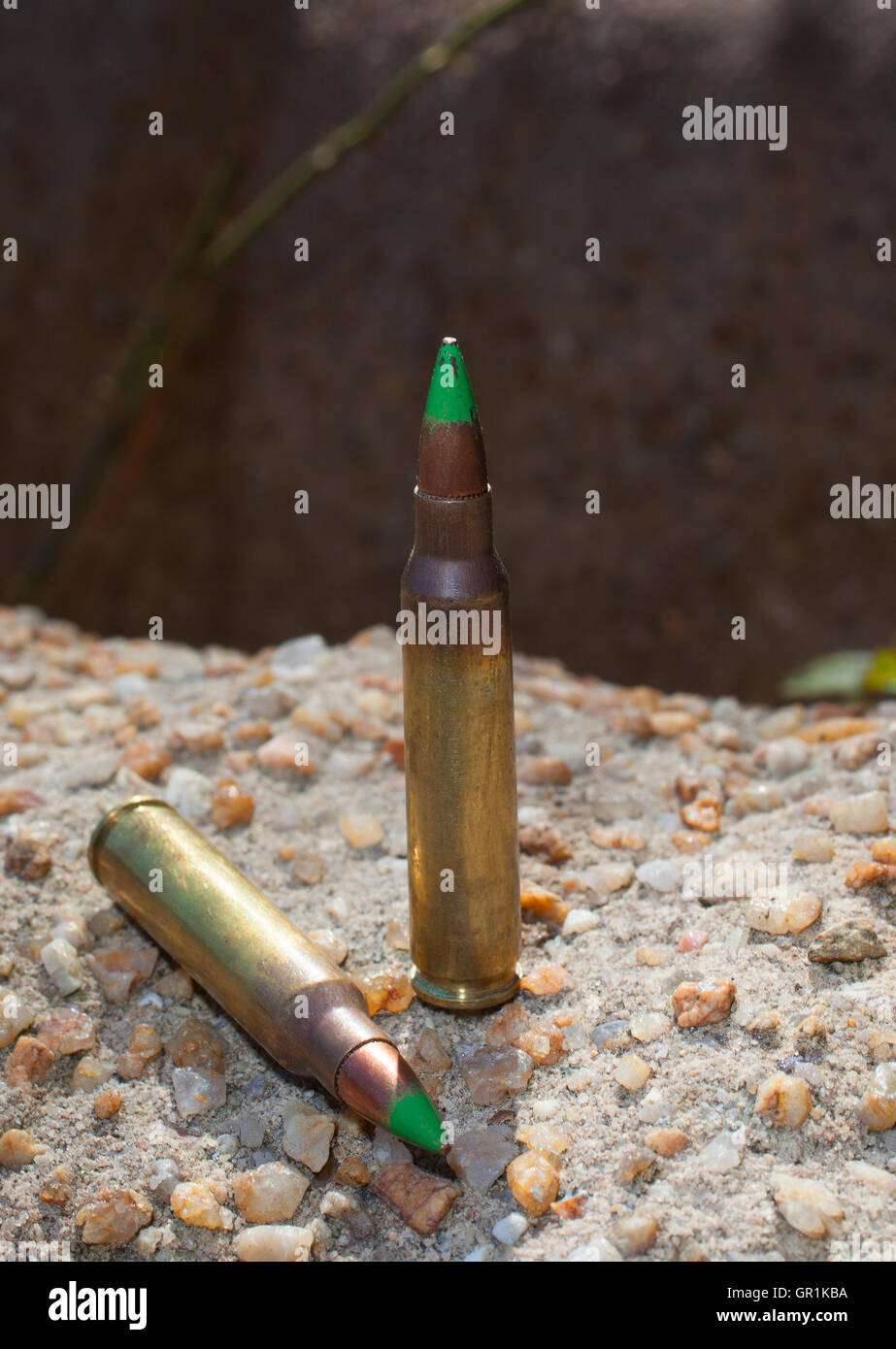 Rifle ammunition that has a green tip on concrete Stock Photo Alamy