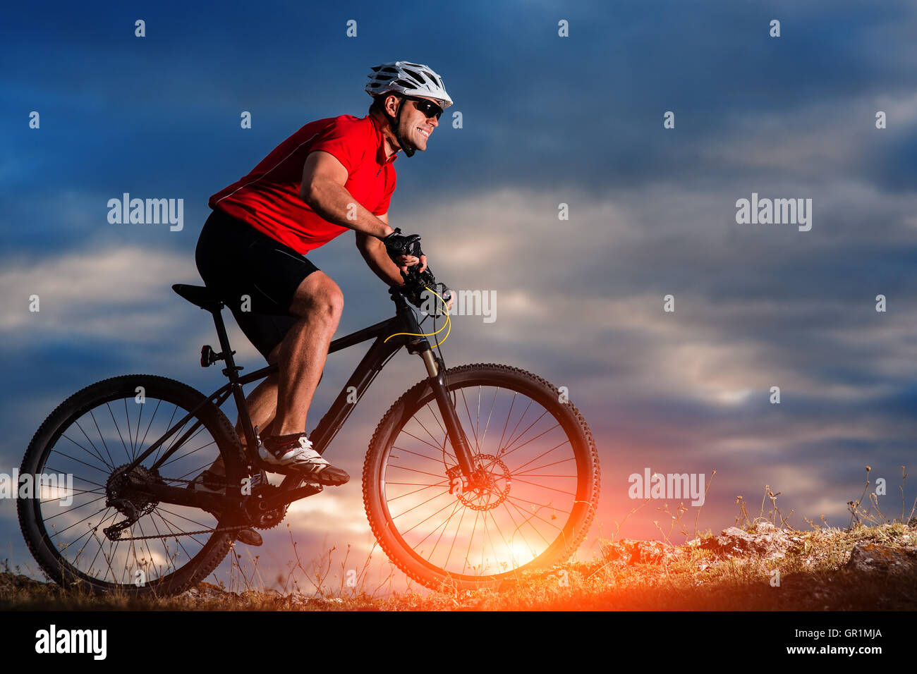 mountain bicycle rider on the hill with sunrise background Stock Photo ...