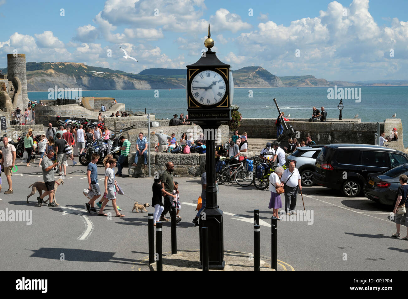 Memorial clock and people in the town Square Lyme Regis, Dorset England UK    KATHY DEWITT Stock Photo