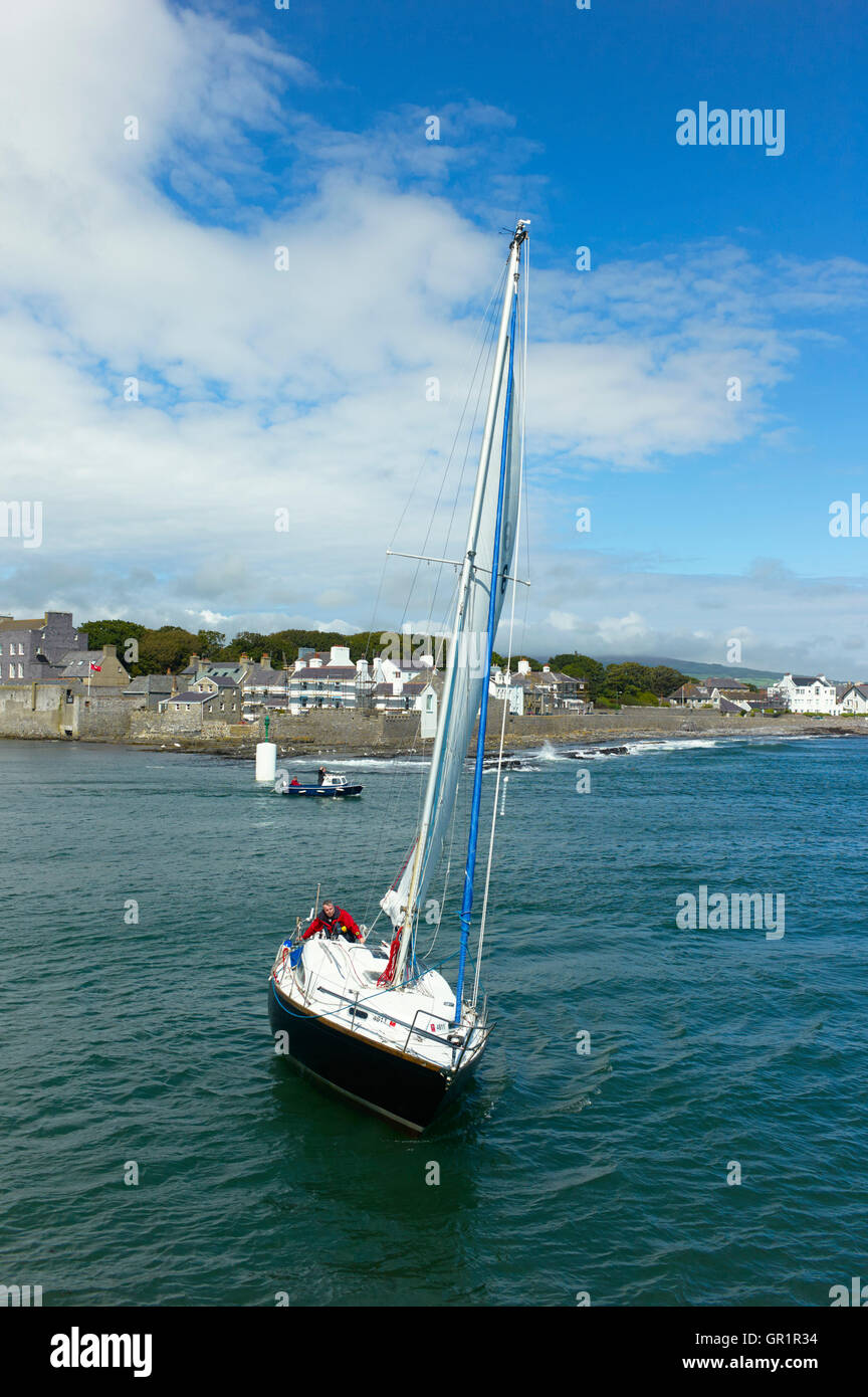 Yacht turning at entrance to Castletown harbour, Isle of Man Stock Photo