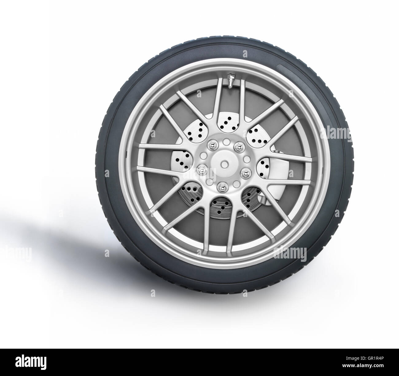 Car wheel against white background with a soft shadow. Clipping path on wheel. Stock Photo